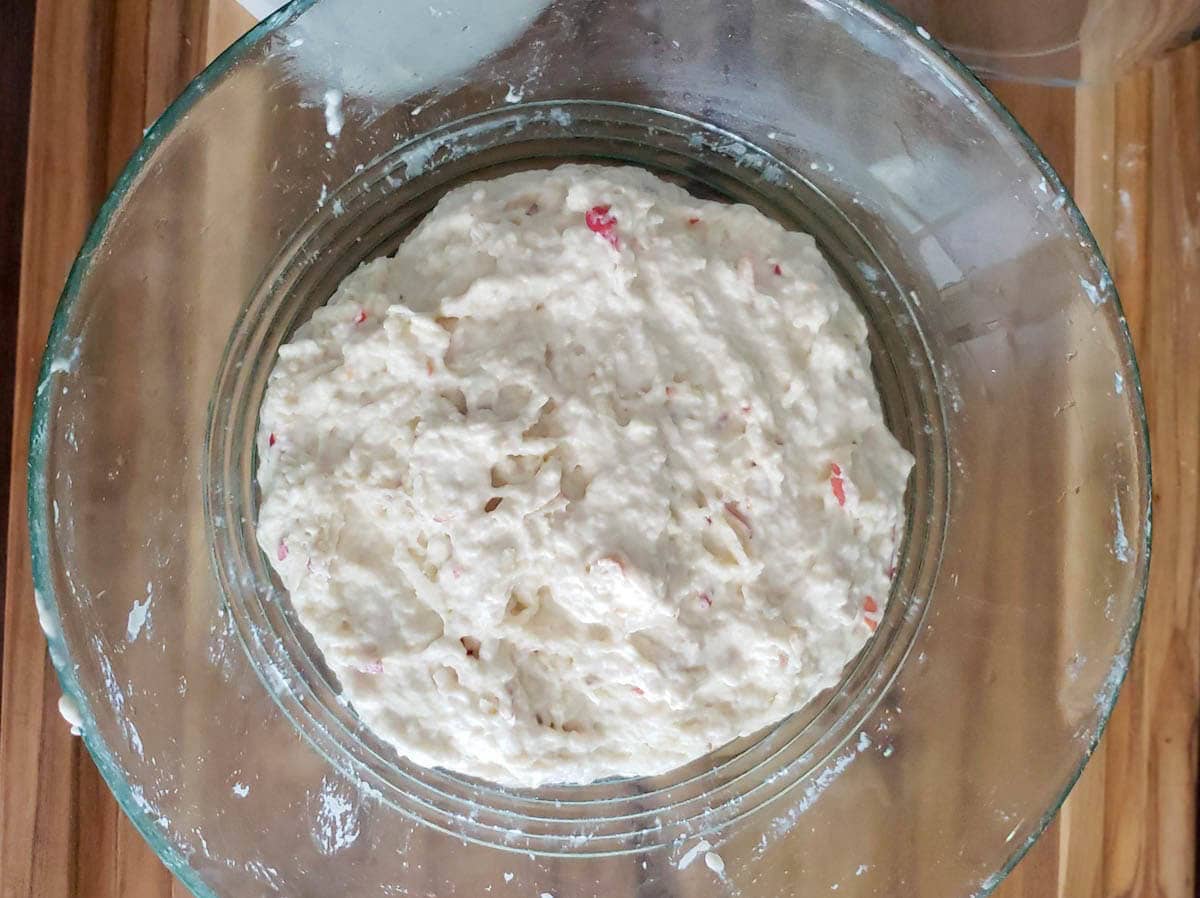 A bowl showing a mixed combination of flour, water, and grated organic apple. The initial stage of the new sourdough starter.