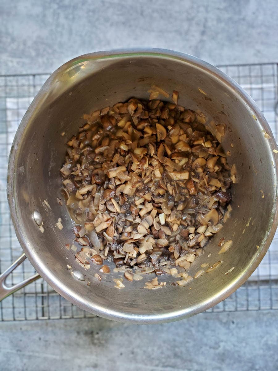 A close up inside a saucepan showing the mushrooms have cooked down and reduced significantly