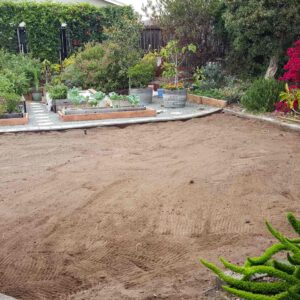 A front yard space that is all bare dirt after the grass has been removed.