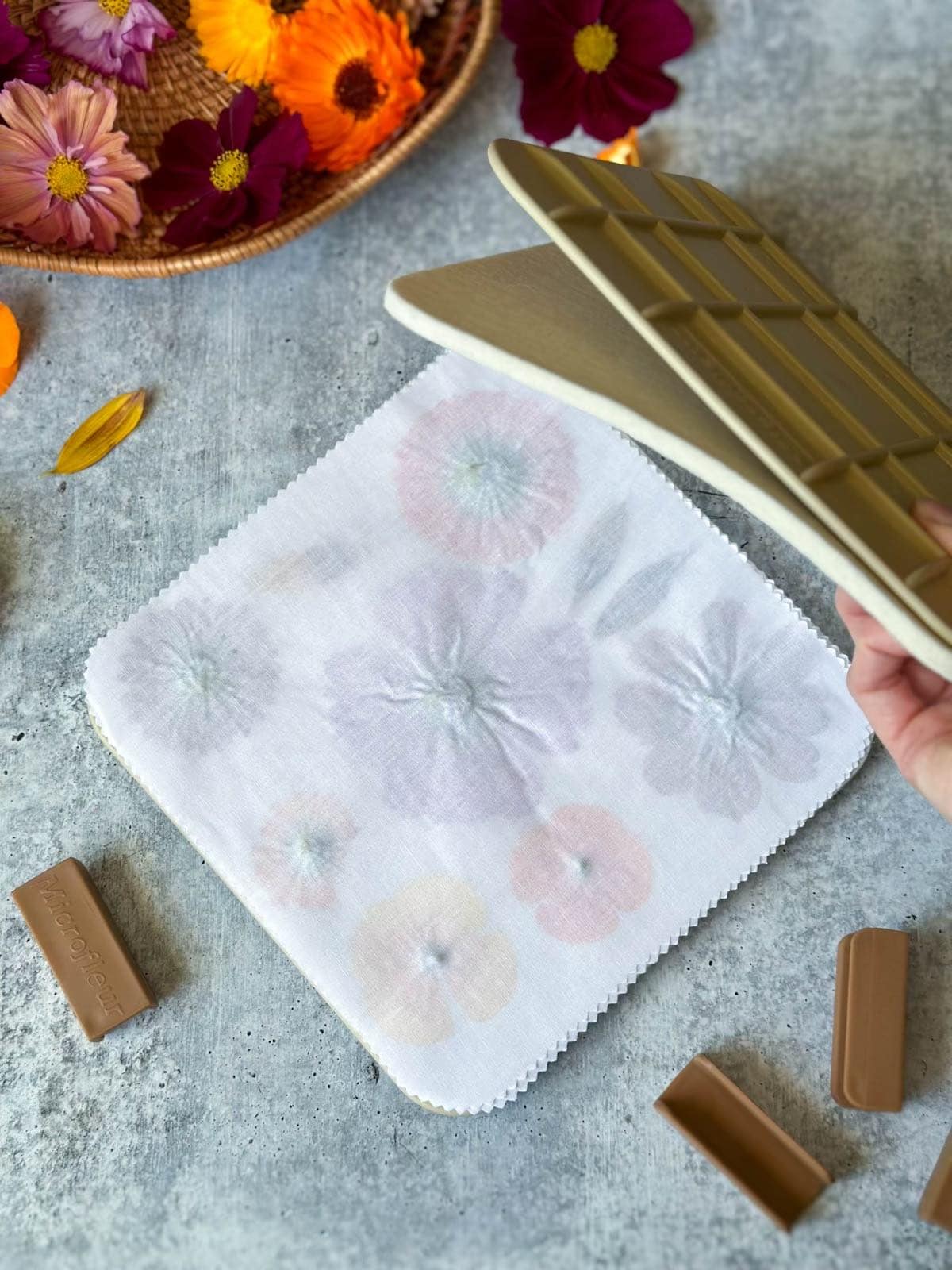 A microwave flower press with a few large flowers sandwiched in the middle. 
