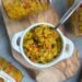 A white ramekin container is full of zucchini relish. A few canned jars of relish lay around the outside of the ramekin.