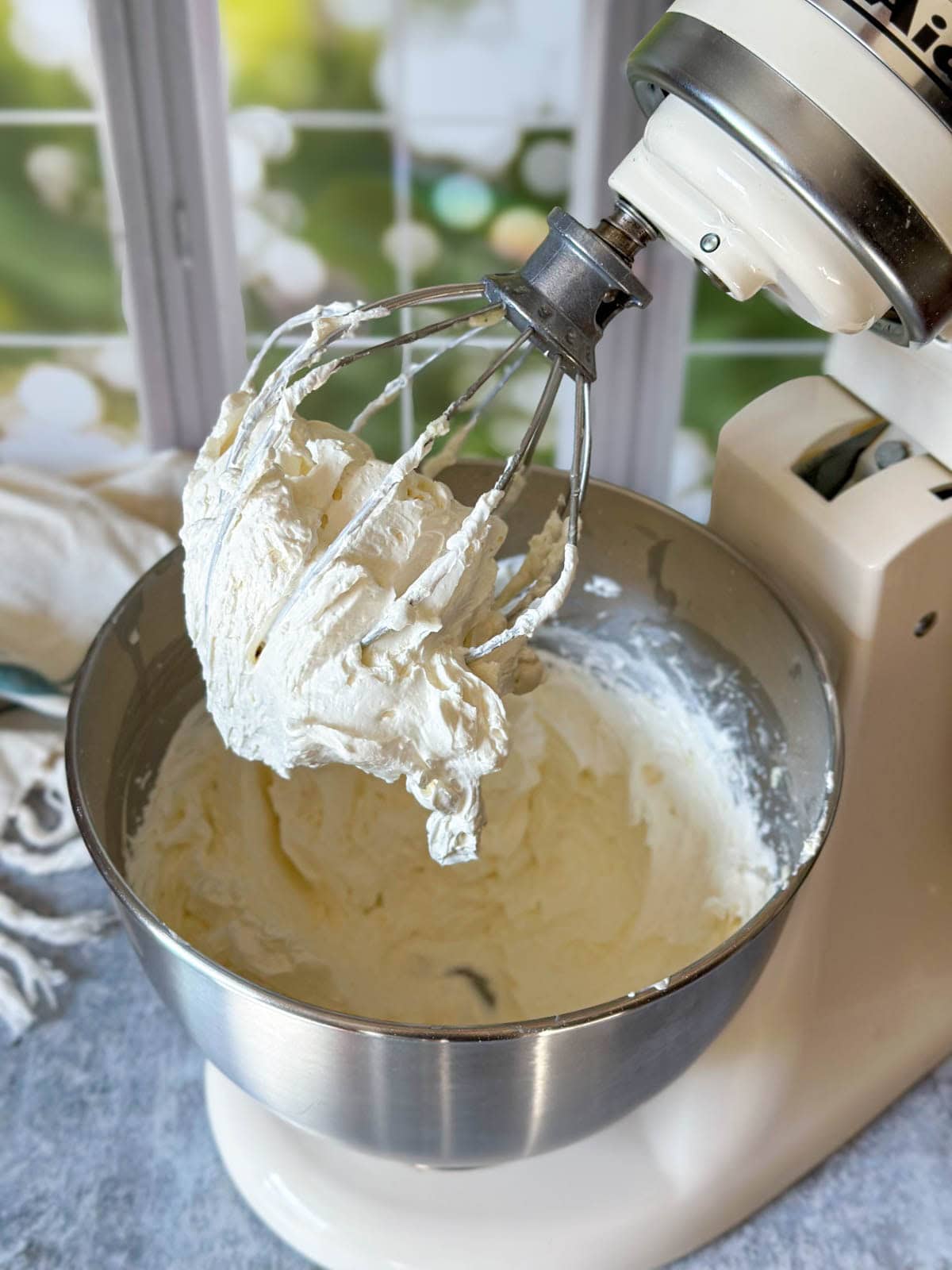 The same stand mixer bowl (kitchen aid) after the body butter has been whipped, and now looks much more white, fluffy and more than double the volume