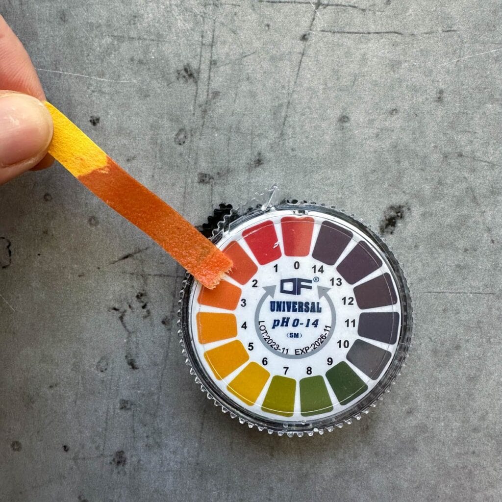 A pH test strip shows the matching color pH of the preserve. 